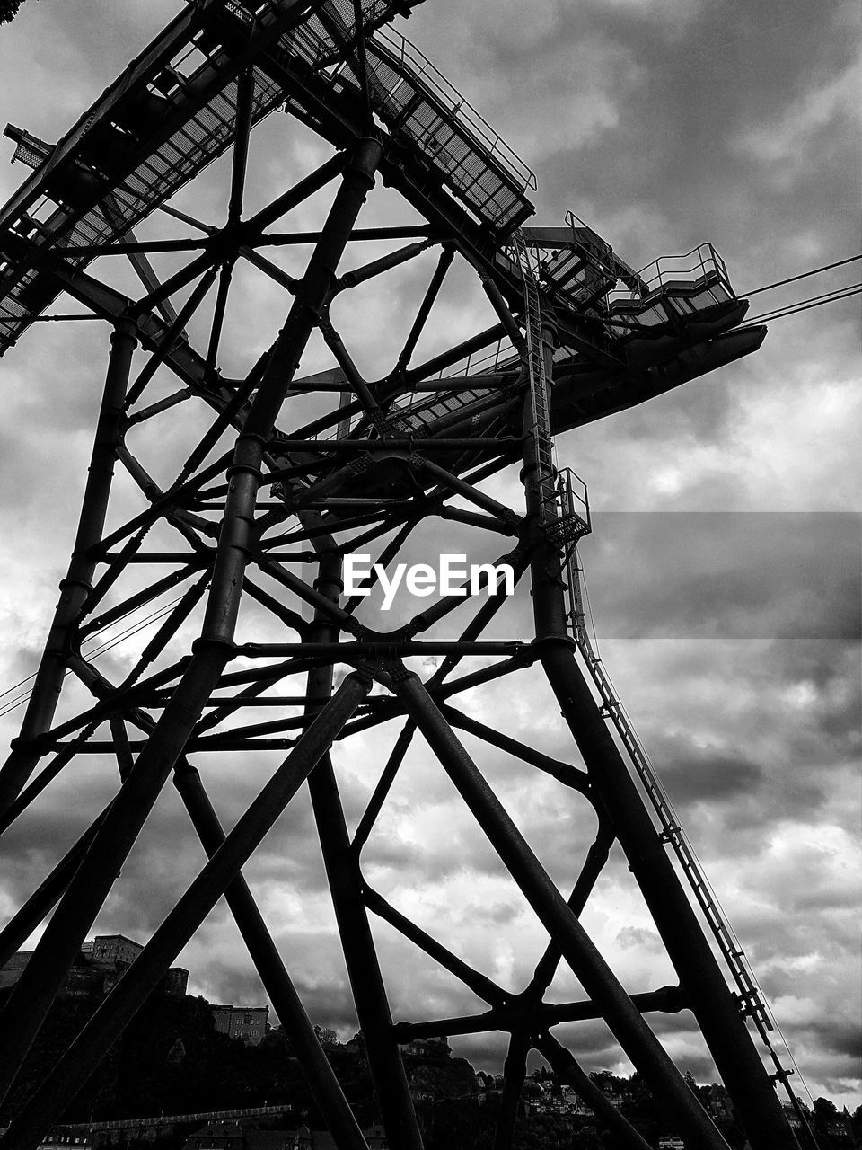 LOW ANGLE VIEW OF AMUSEMENT PARK AGAINST CLOUDY SKY