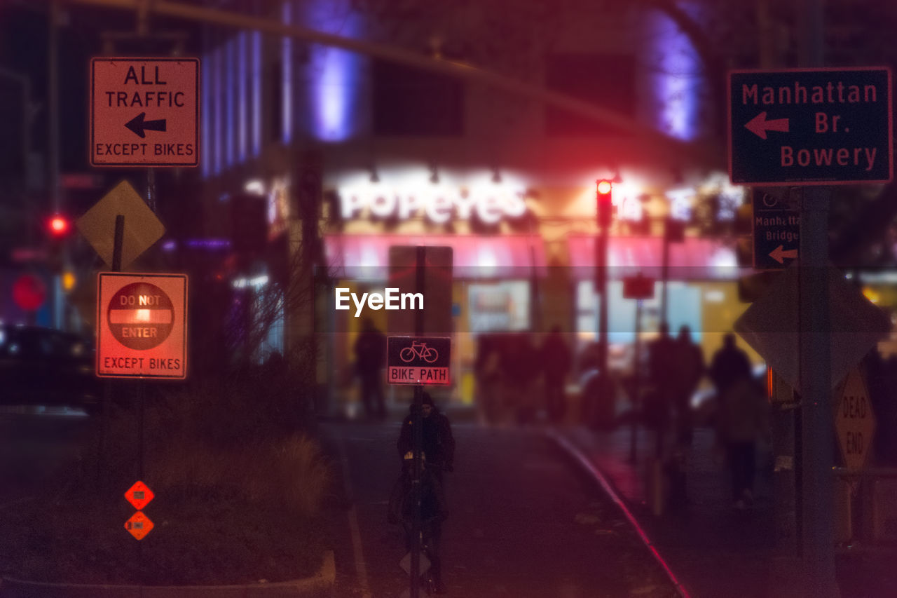 Information sign at roadside in city during night