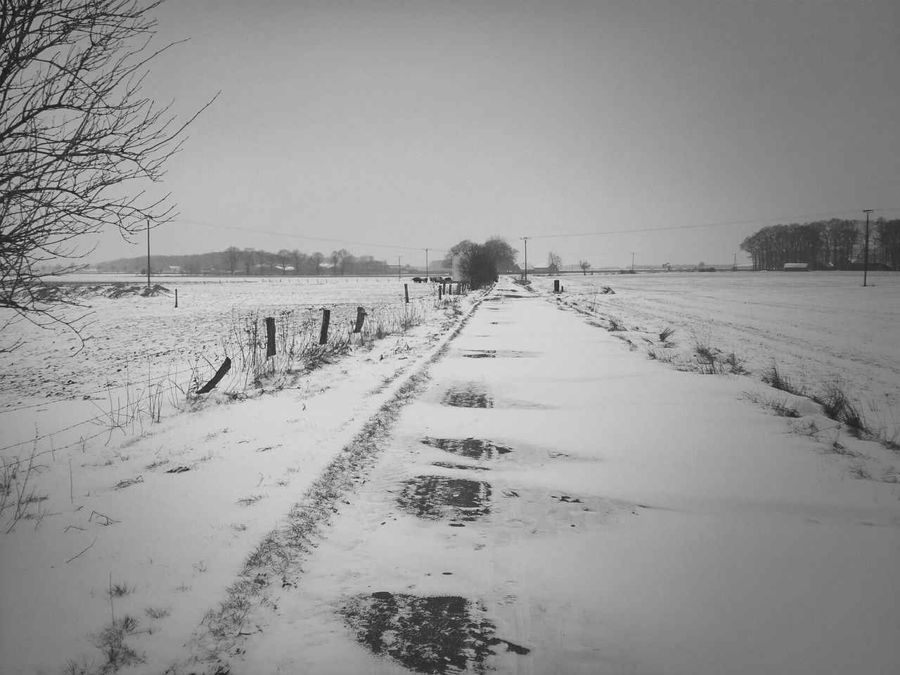 Snow covered road against clear sky