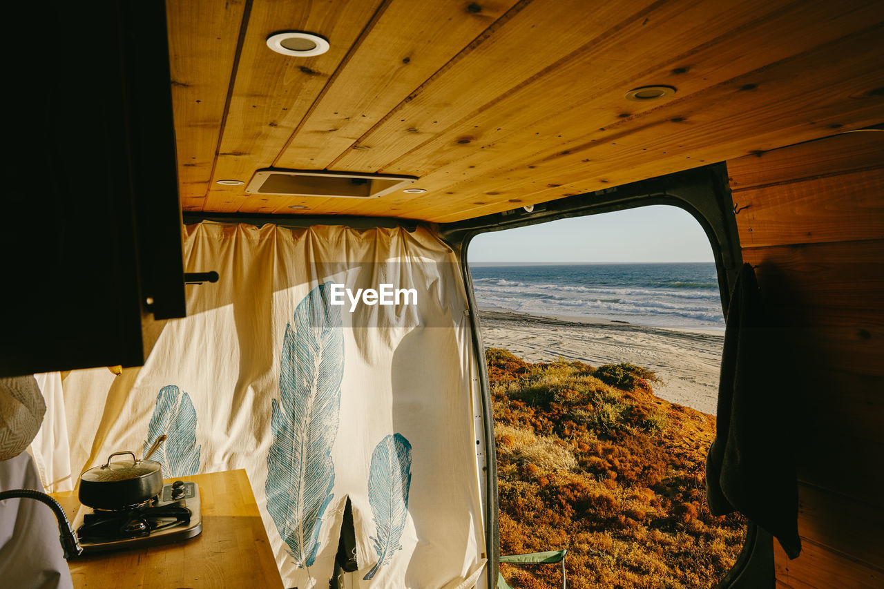 Interior of camper van parked on cliff during sunset in baja, mexico.