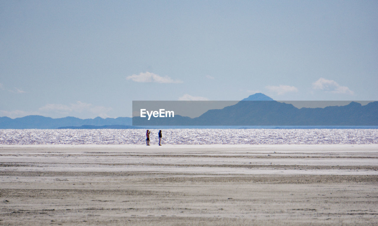 SCENIC VIEW OF SEA WITH MOUNTAINS IN BACKGROUND