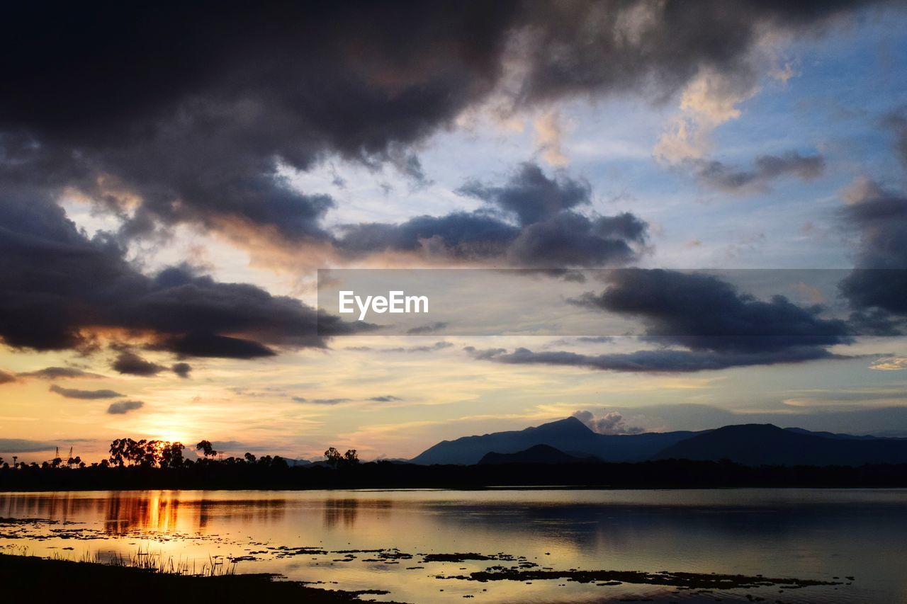 SCENIC VIEW OF DRAMATIC SKY OVER LAKE DURING SUNSET