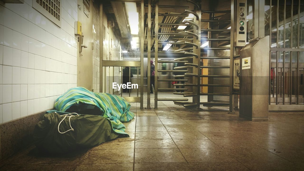 Homeless man sleeping in underground walkway