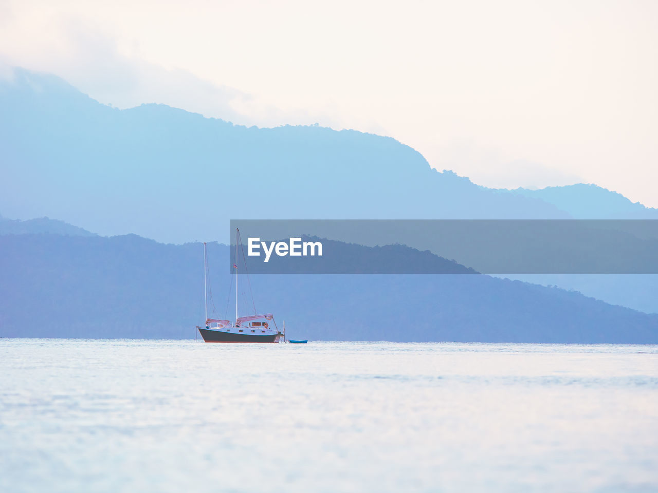 Lonely boat on clam sea background. pastel colors.