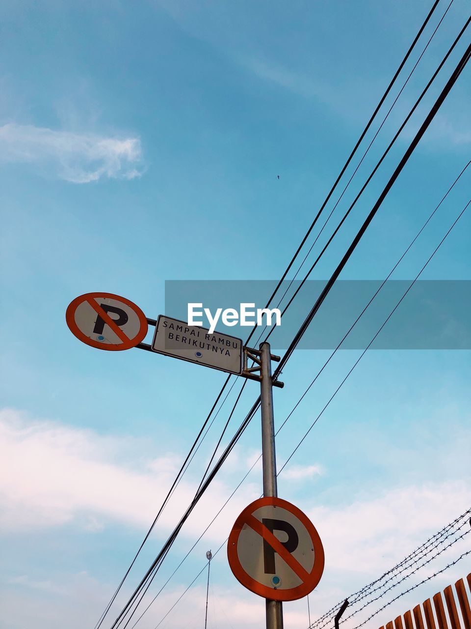 Low angle view of road sign against sky