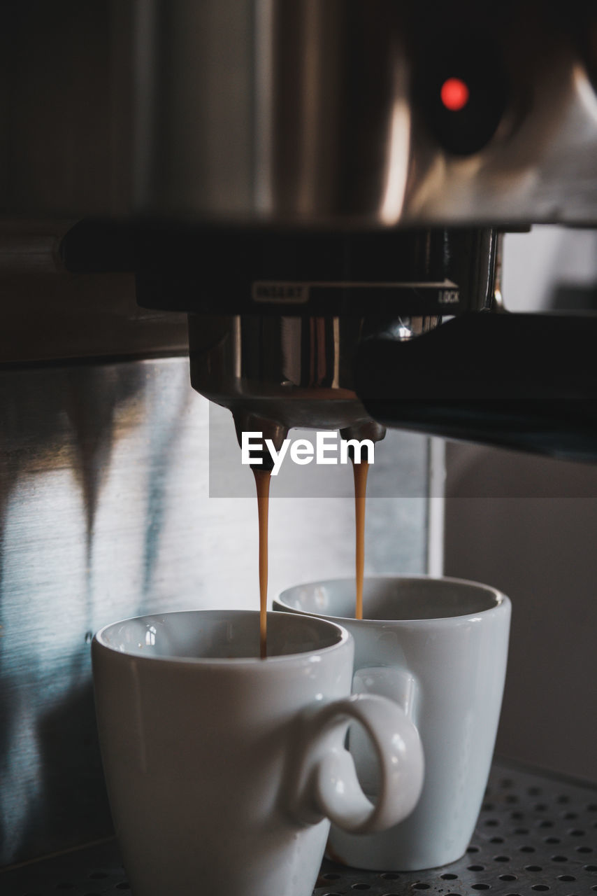 CLOSE-UP OF COFFEE POURING IN CUP