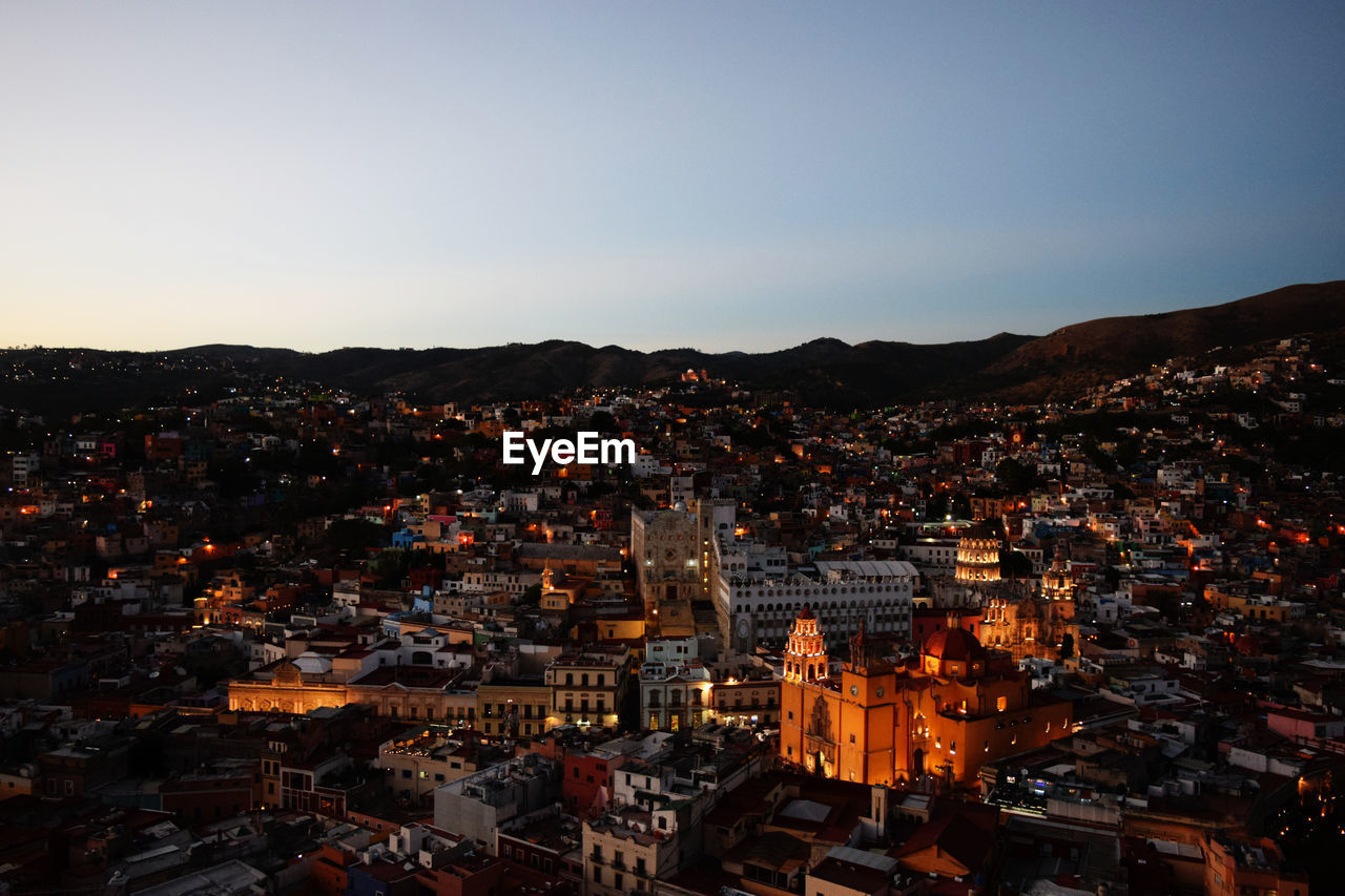 High angle shot of illuminated cityscape against sky at night