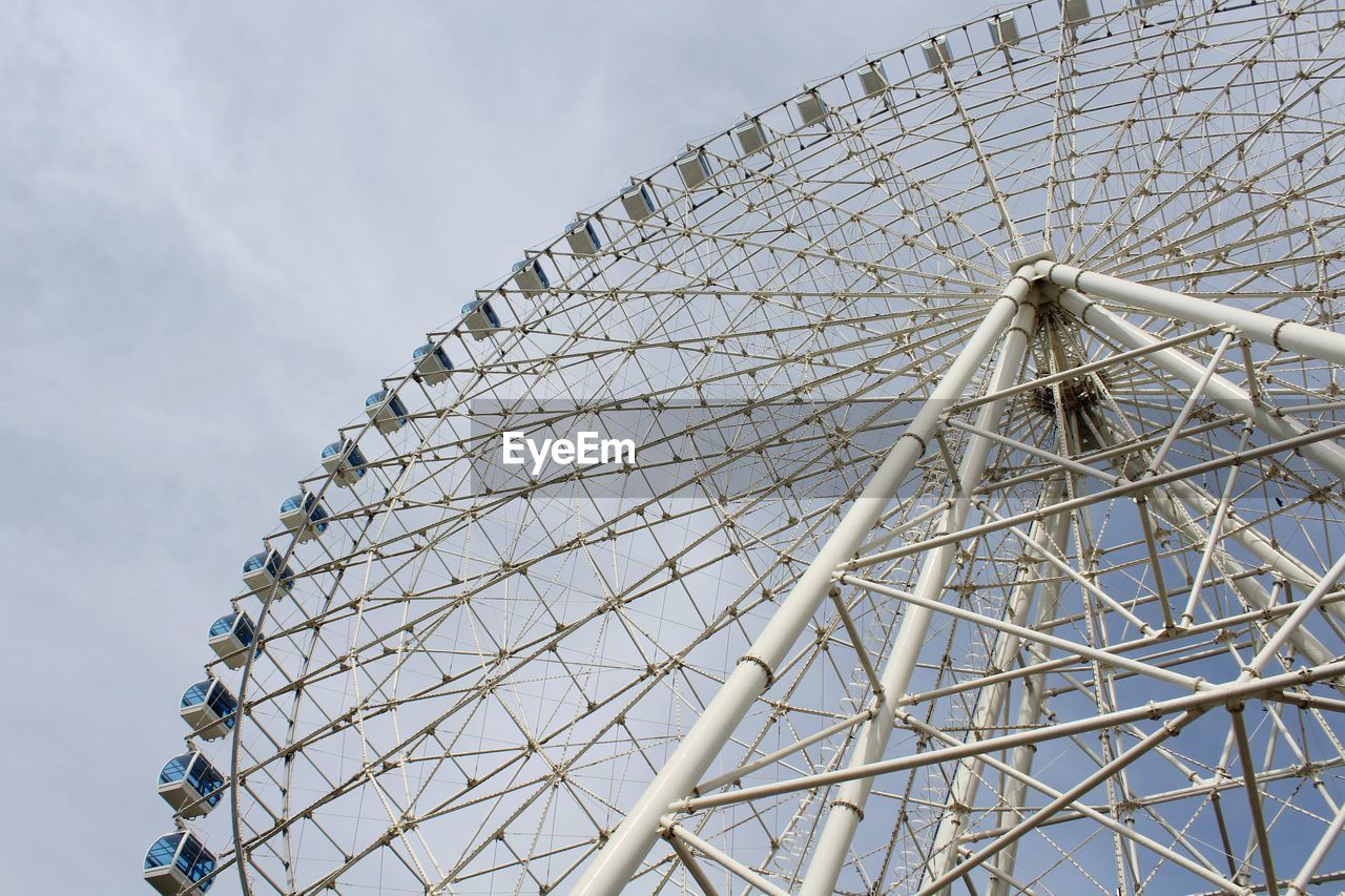 Low angle view of ferris wheel against sky