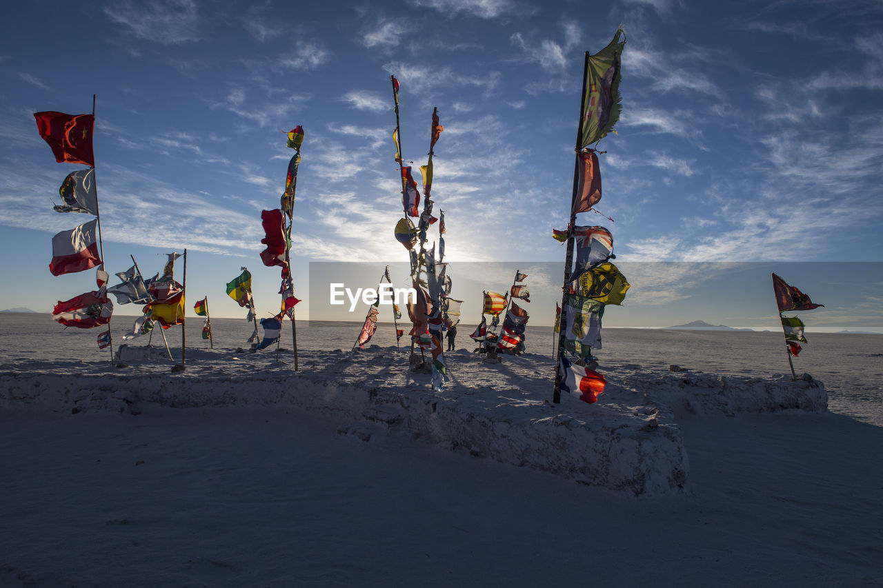 International flags planted on the salt flats of uyuni in bolivia