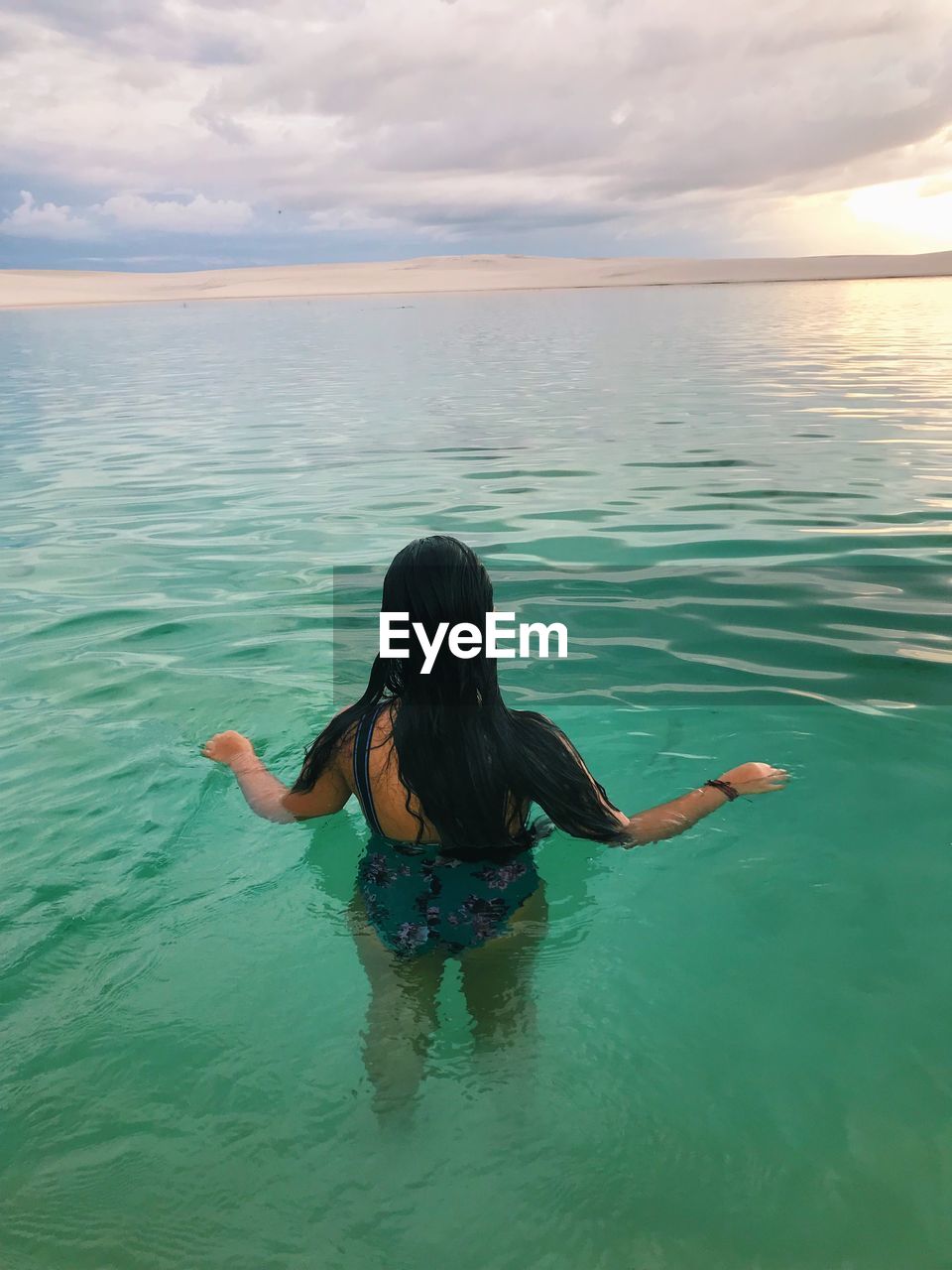 Rear view of a woman swimming in the lençóis maranhenses nacional park 