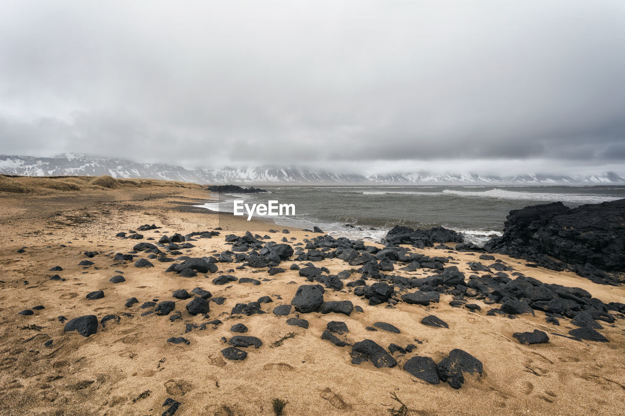 Scenic view of beach against sky during winter