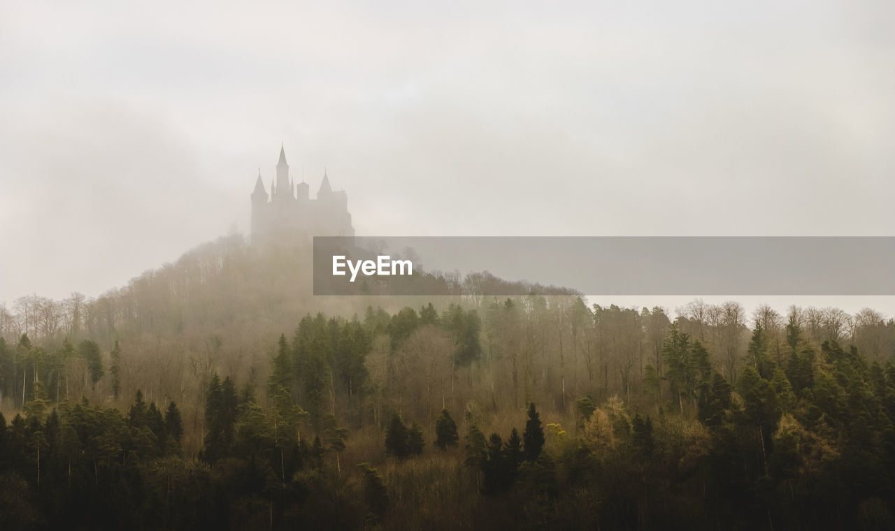 Castle on top of foggy mountain