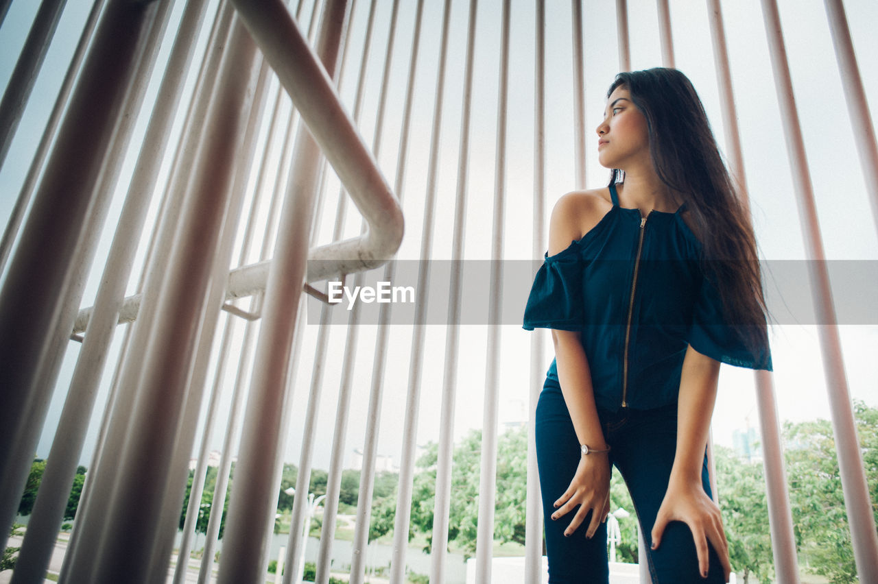 Low angle view of woman looking away