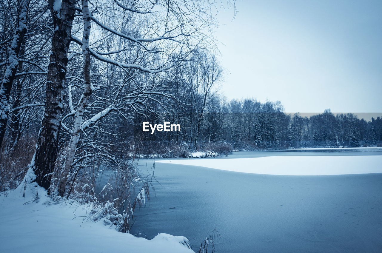 Scenic view of snow covered landscape against clear sky