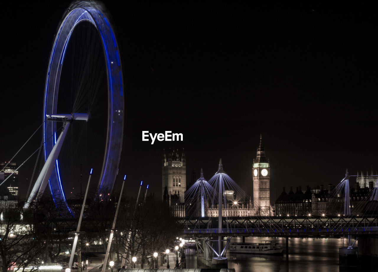 Golden jubilee bridge over thames river with illuminated london eye