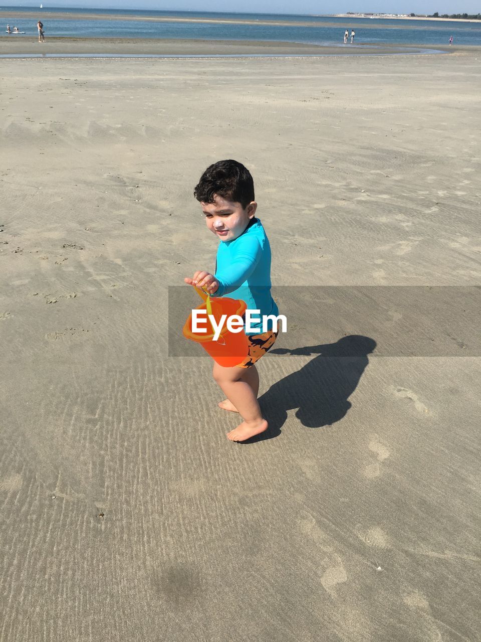 HIGH ANGLE VIEW OF BOY ON SHORE