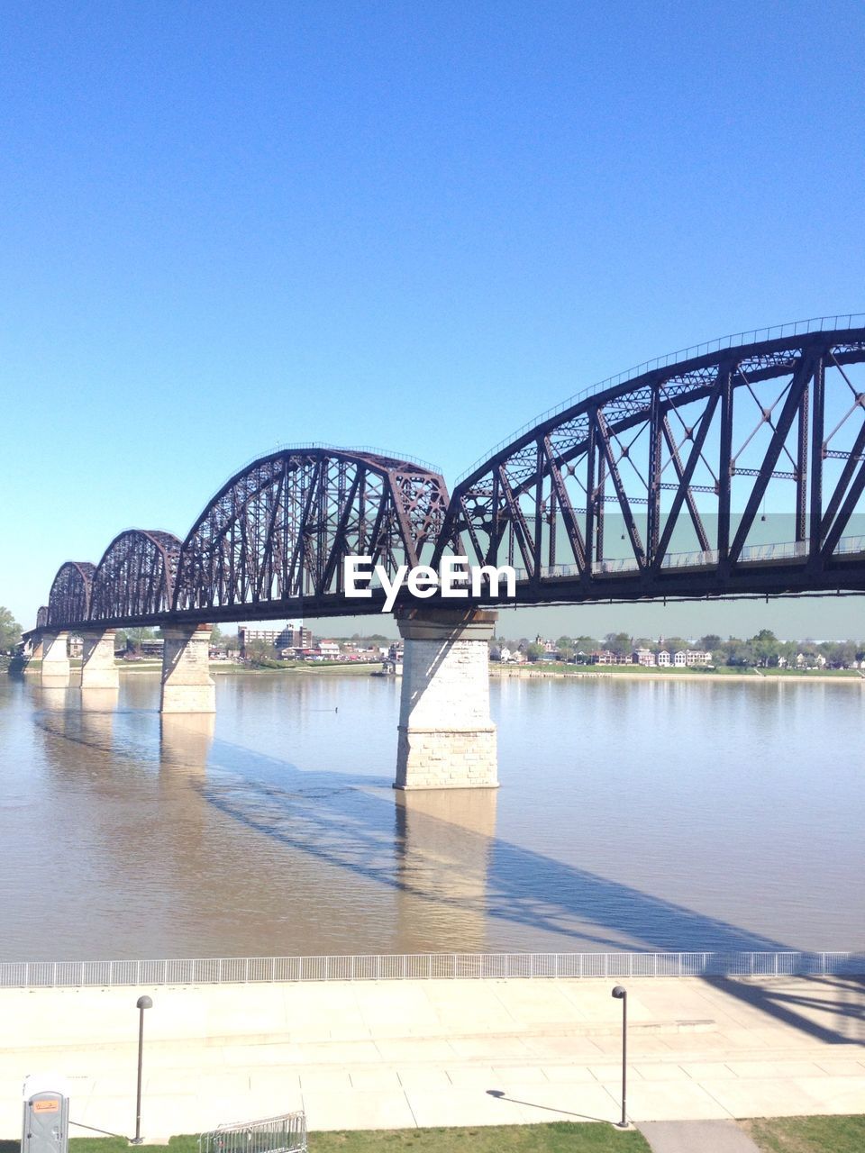 Bridge over river against blue sky