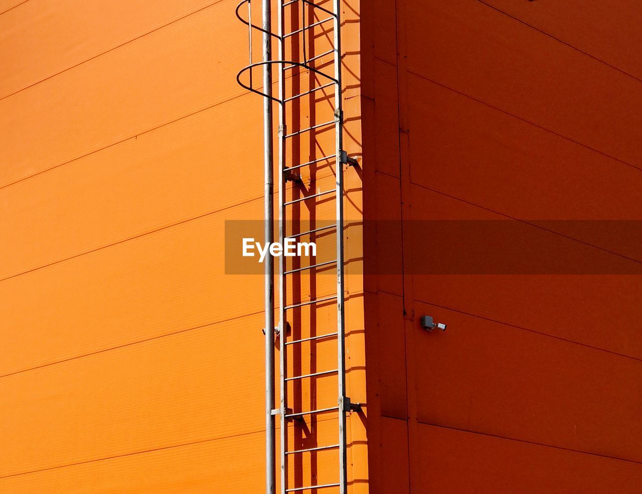 Full frame shot of orange building during sunny day