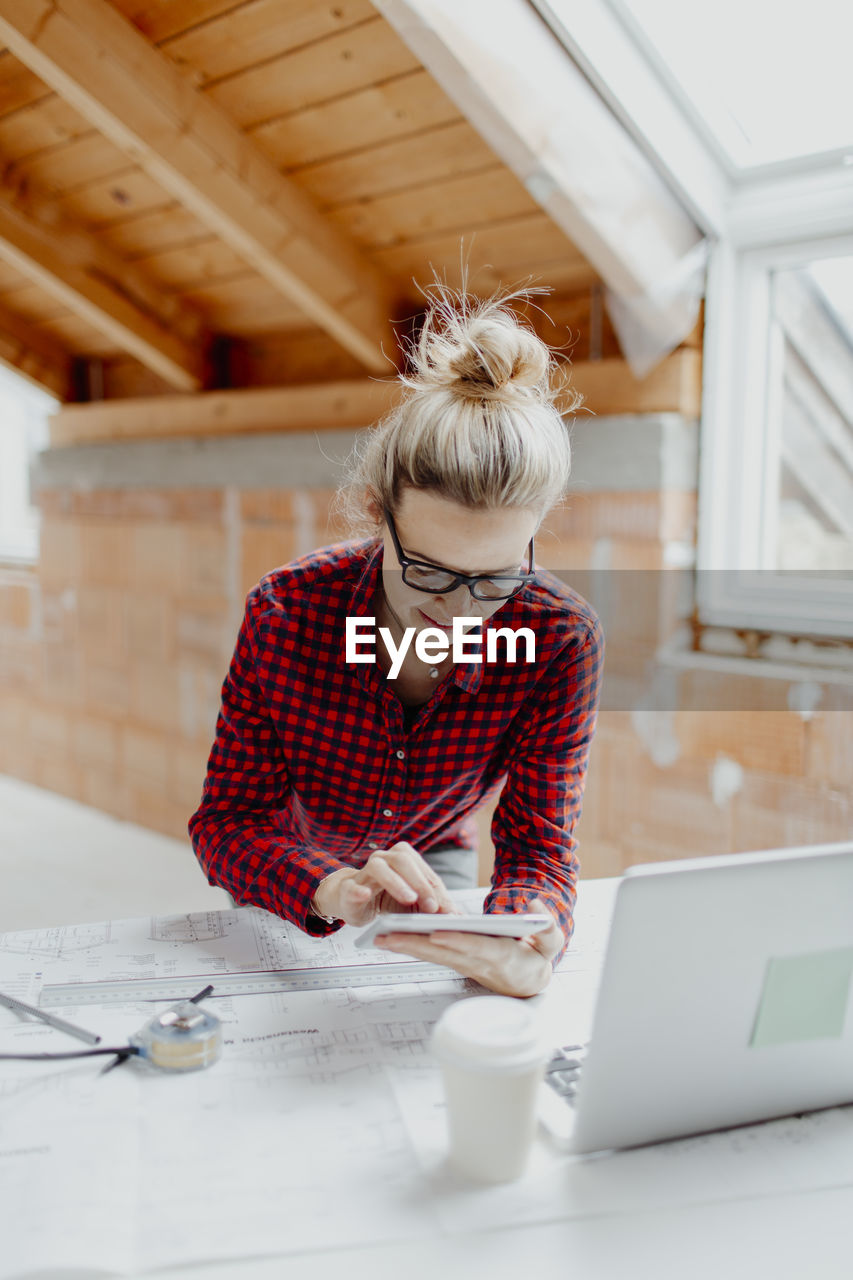 Female architect working at desk in office