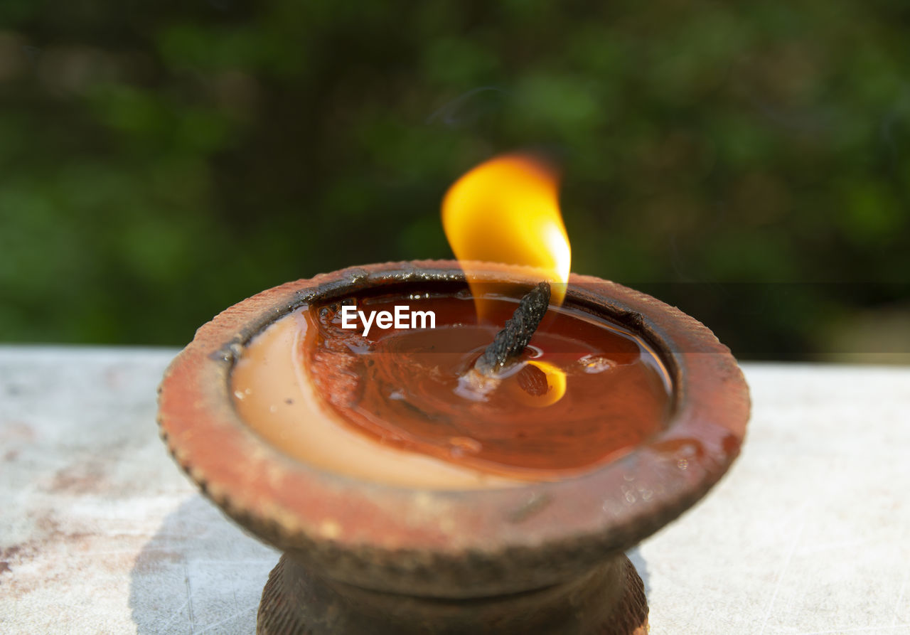 candle, burning, heat, macro photography, nature, fire, close-up, flame, no people, focus on foreground, food and drink, yellow, outdoors, food, day, wood