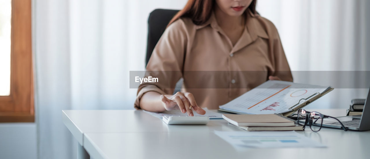 Midsection of businesswoman at office