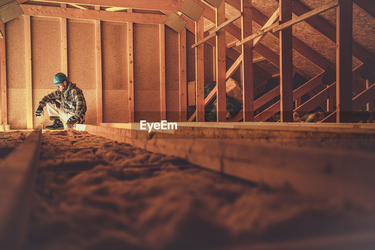 MAN WORKING AT CONSTRUCTION SITE IN MUSEUM