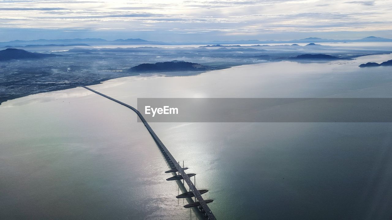 Aerial view of sea against cloudy sky