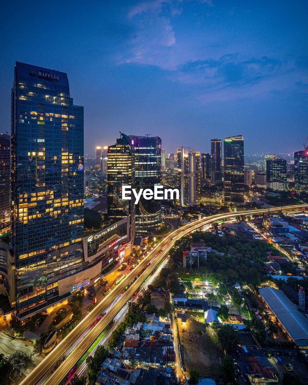 High angle view of illuminated city street and buildings at night