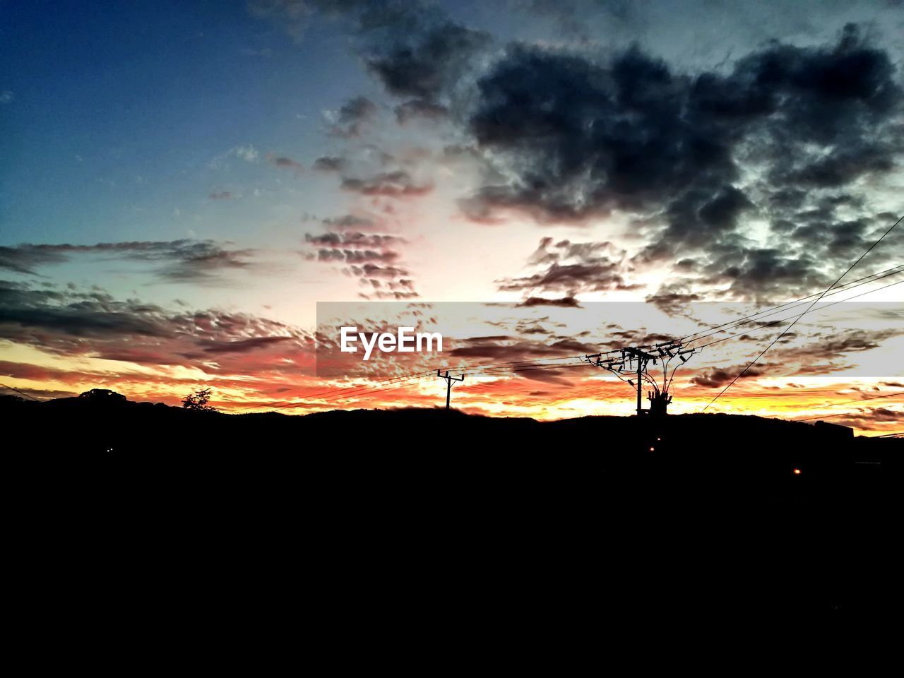 SCENIC VIEW OF DRAMATIC SKY OVER SILHOUETTE LANDSCAPE