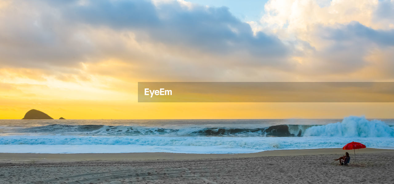 SCENIC VIEW OF BEACH DURING SUNSET