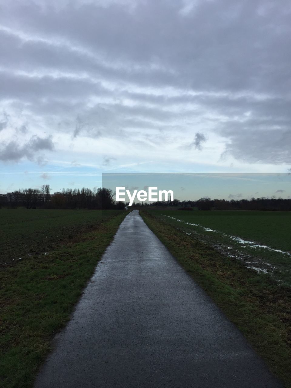 ROAD AMIDST FIELD AGAINST SKY DURING SUNSET