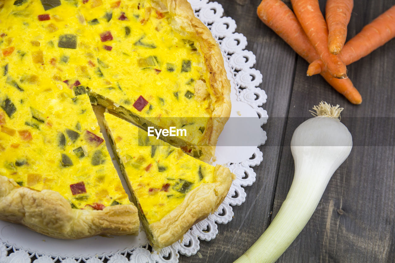 High angle view of yellow tart on table