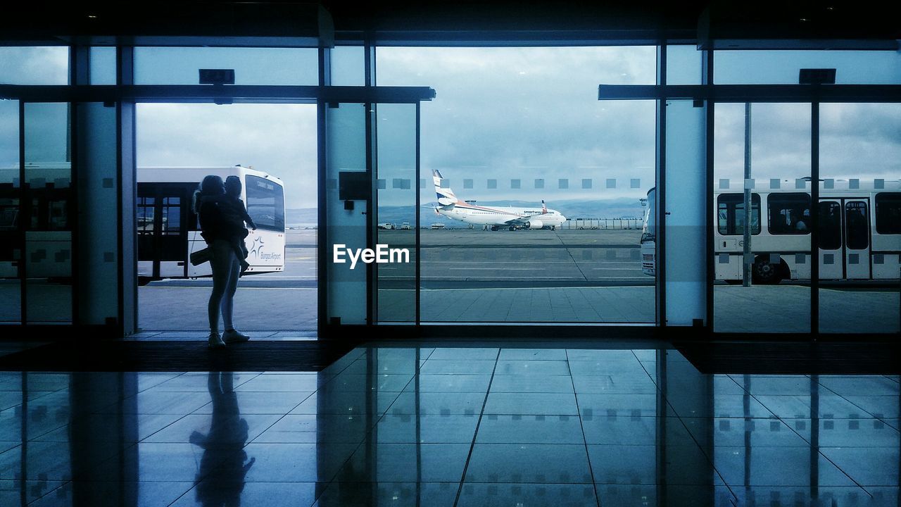 Woman with child standing at airport