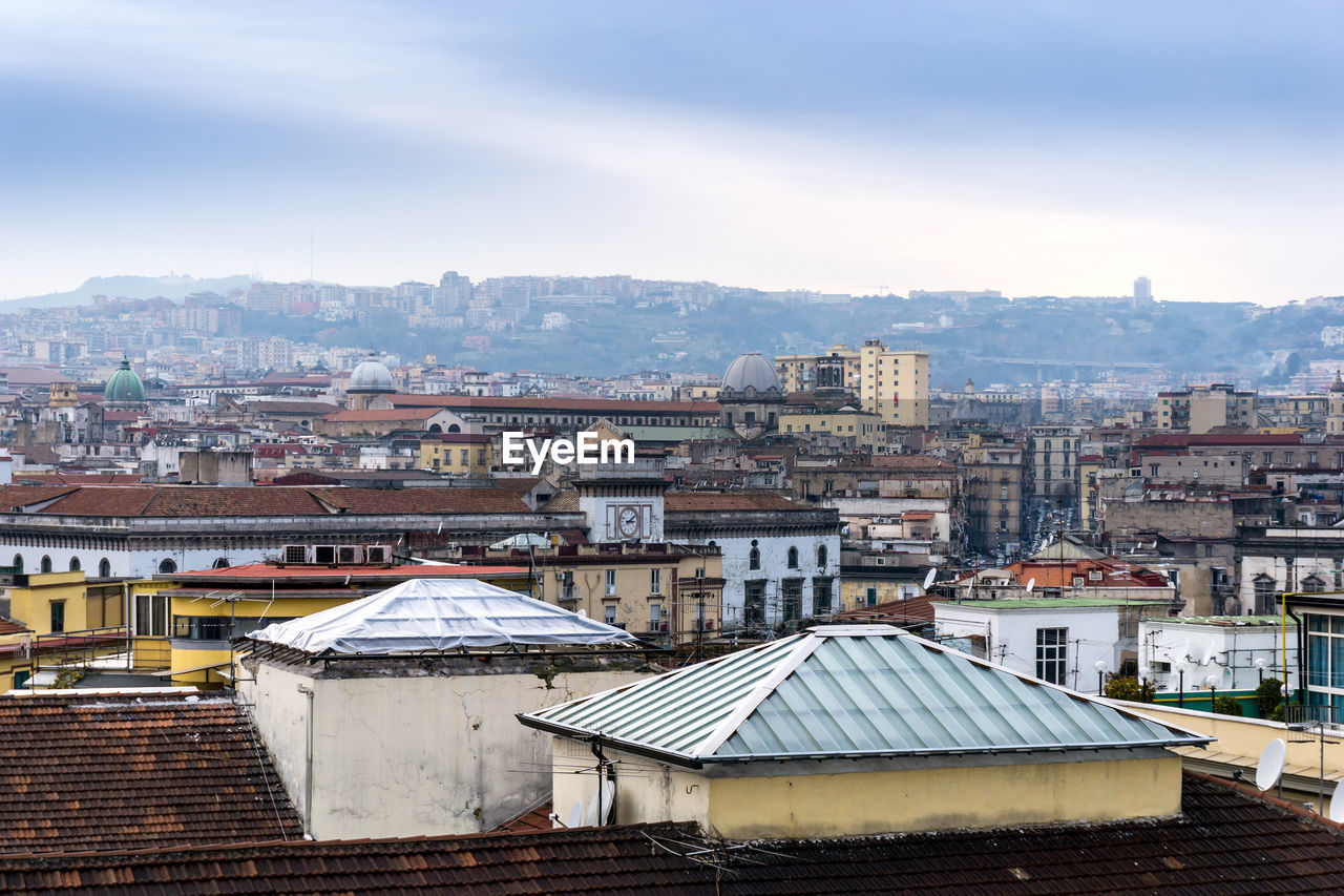 Houses in city against sky