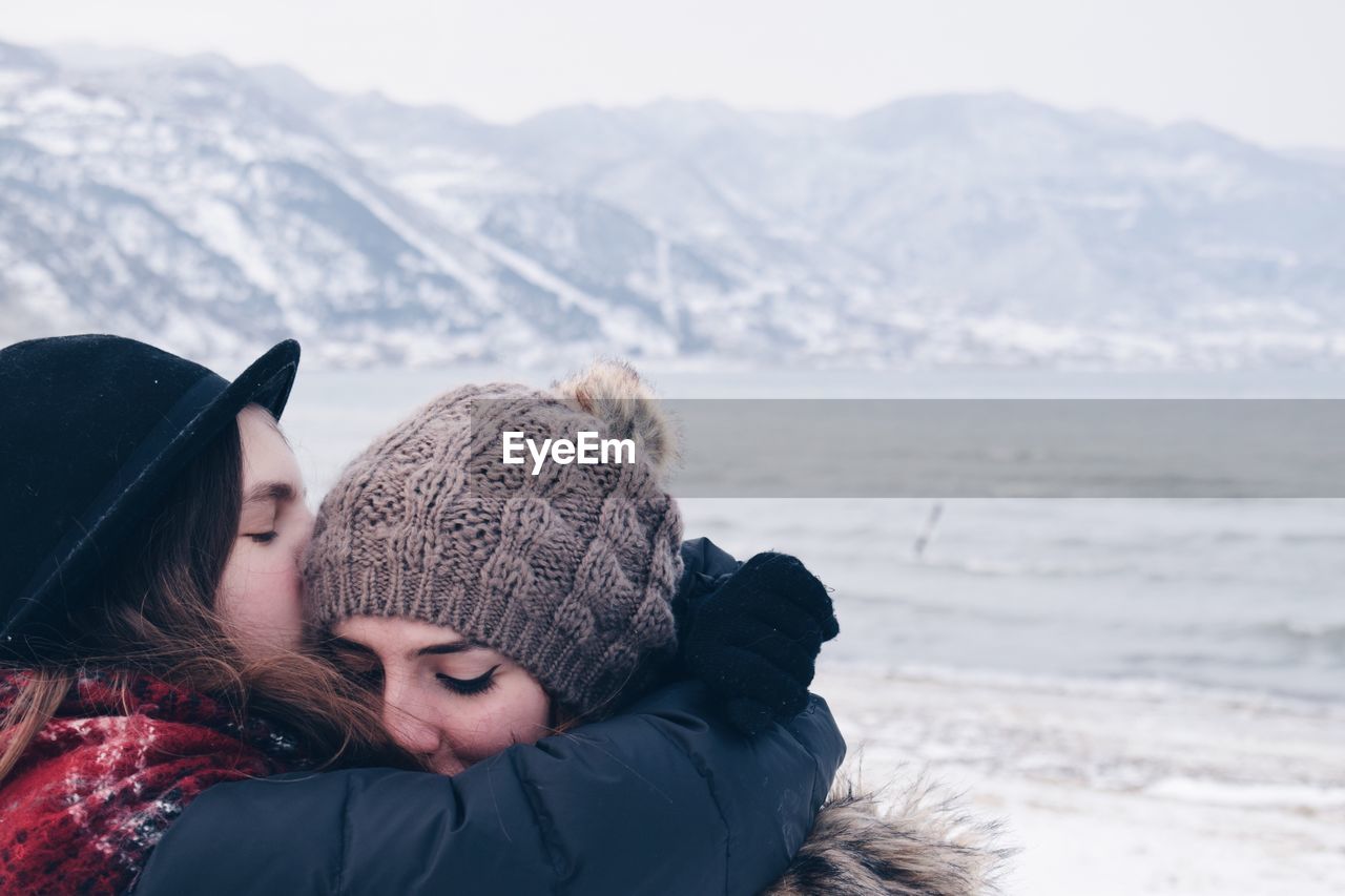 CLOSE-UP OF YOUNG WOMAN IN SNOW