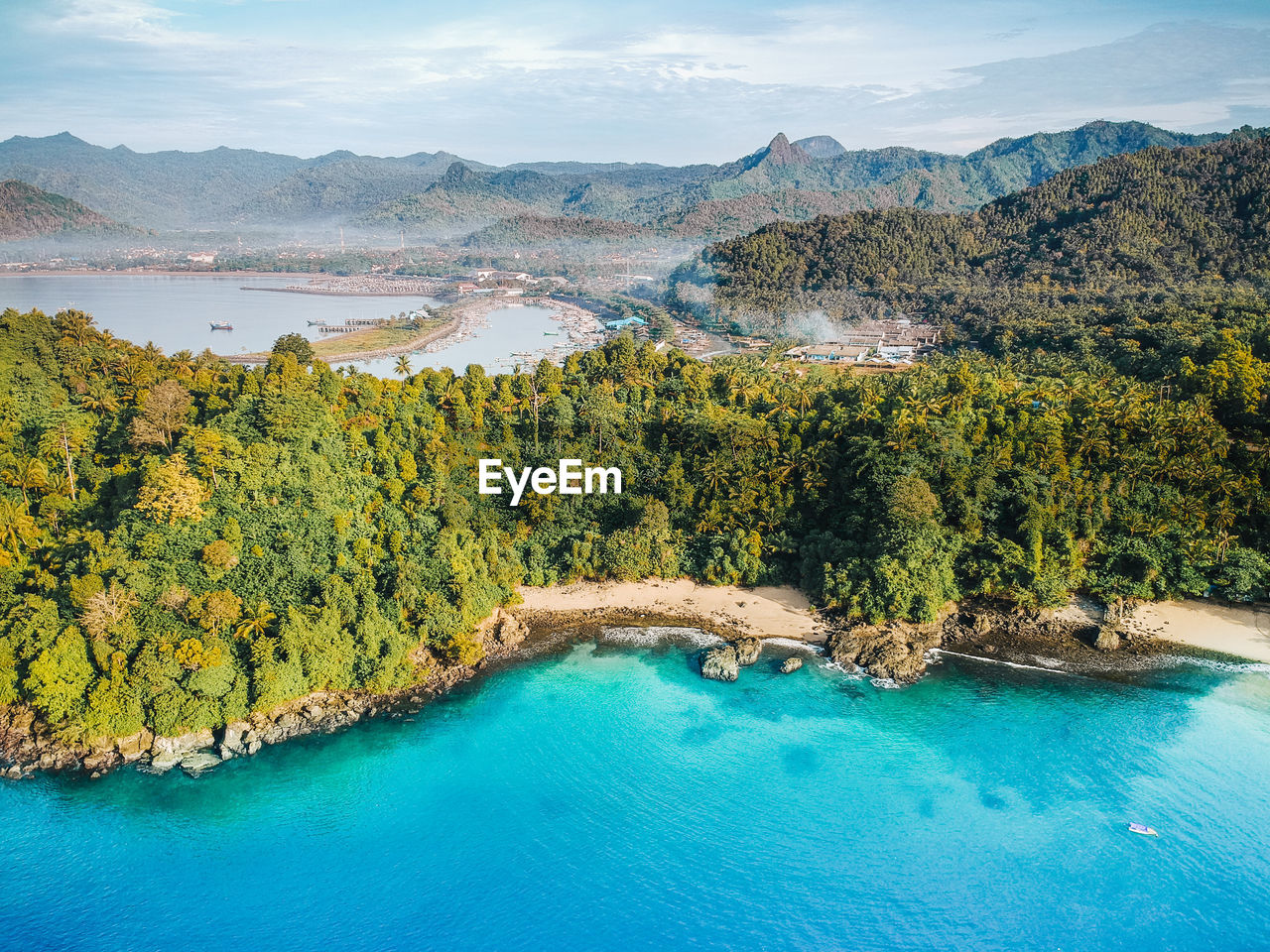 Scenic view of lake by trees against sky