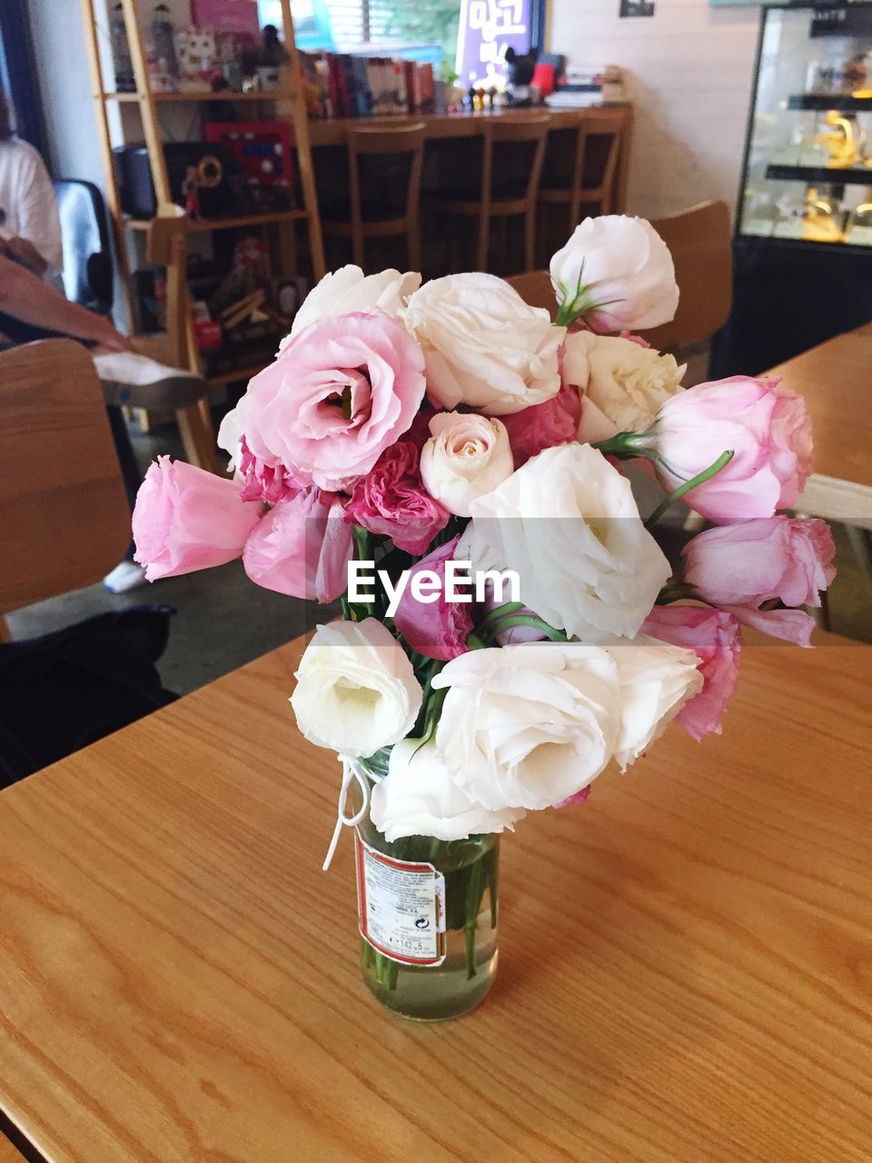 High angle view of flowers in bottle on wooden table