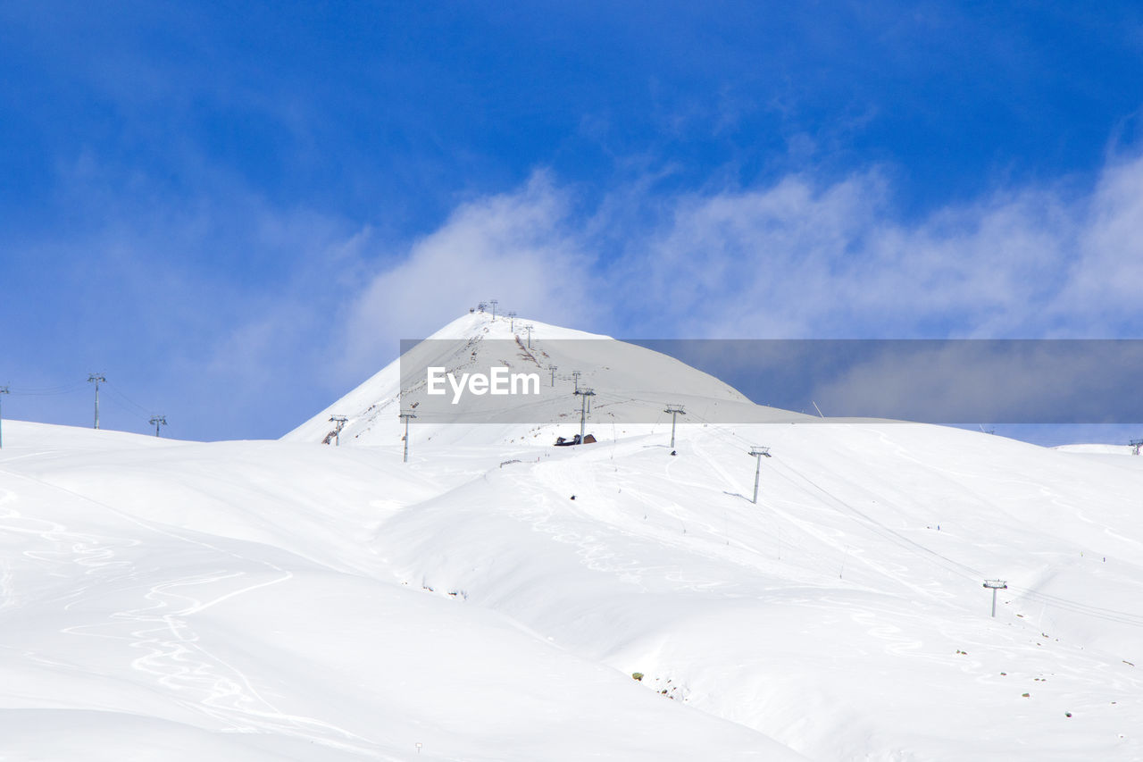 Georgian ski resort in gudauri. snowy mountains, daytime and sunlight.