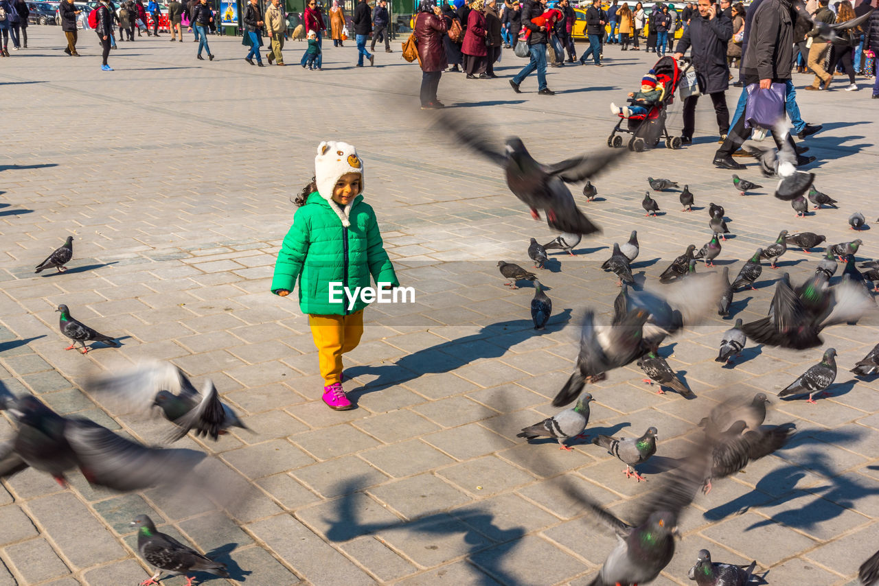 PEOPLE WALKING ON STREET IN CITY