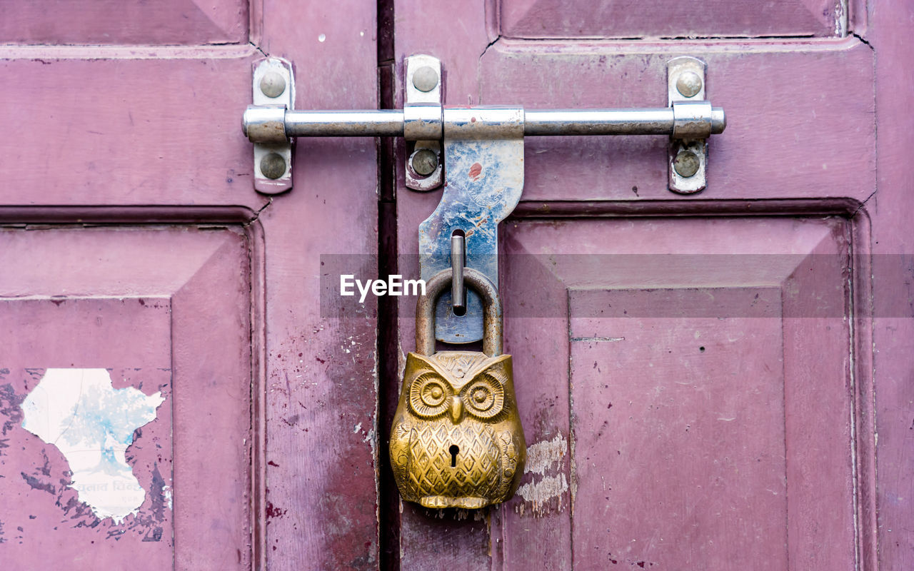 close-up of rusty padlock on closed door