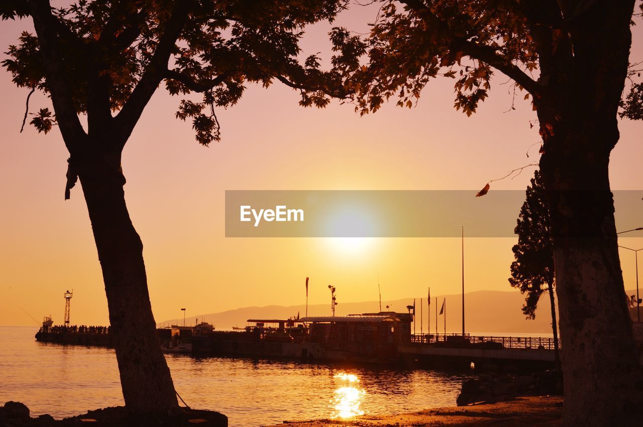 Silhouette of boat at sea against sky during sunset