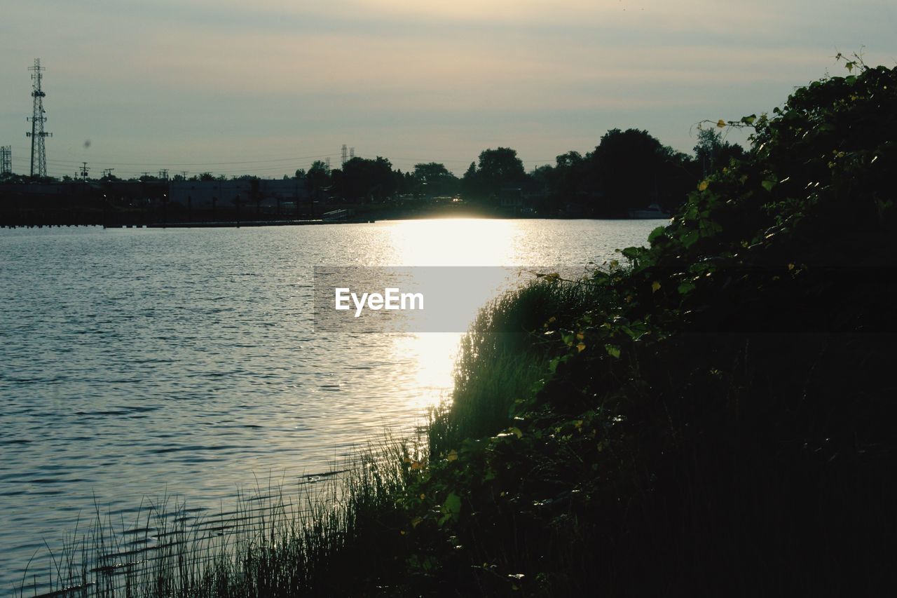 SCENIC VIEW OF LAKE AT SUNSET