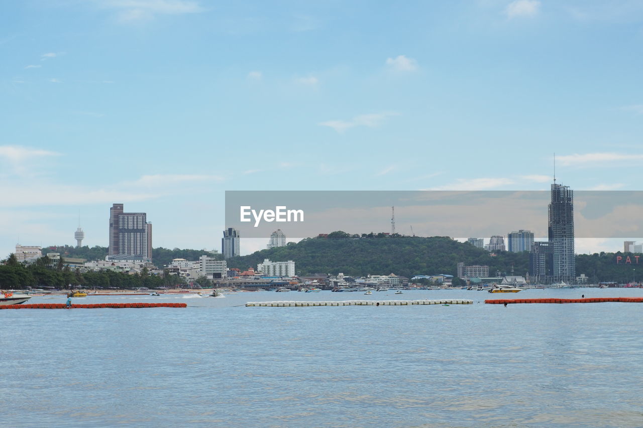 SEA AND BUILDINGS AGAINST SKY