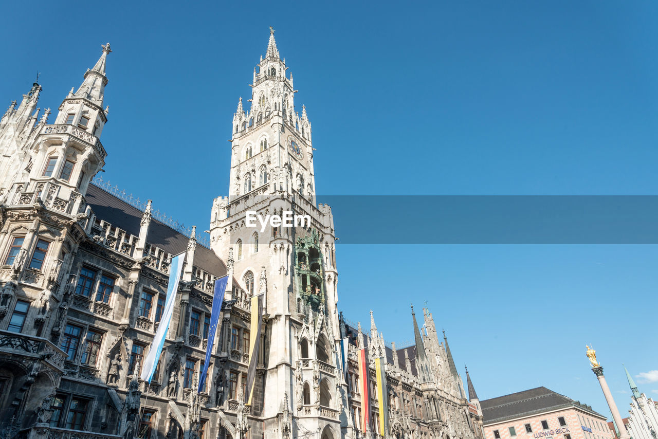 Low angle view of rathausgalerie at marienplatz against clear blue sky