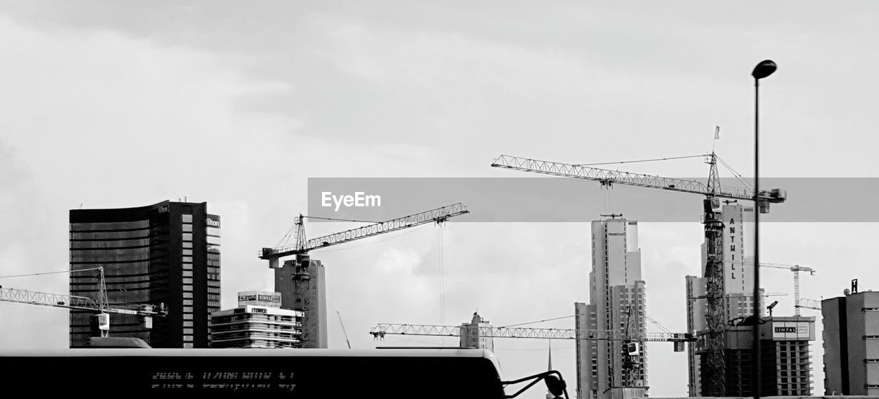 LOW ANGLE VIEW OF CRANE AGAINST SKY