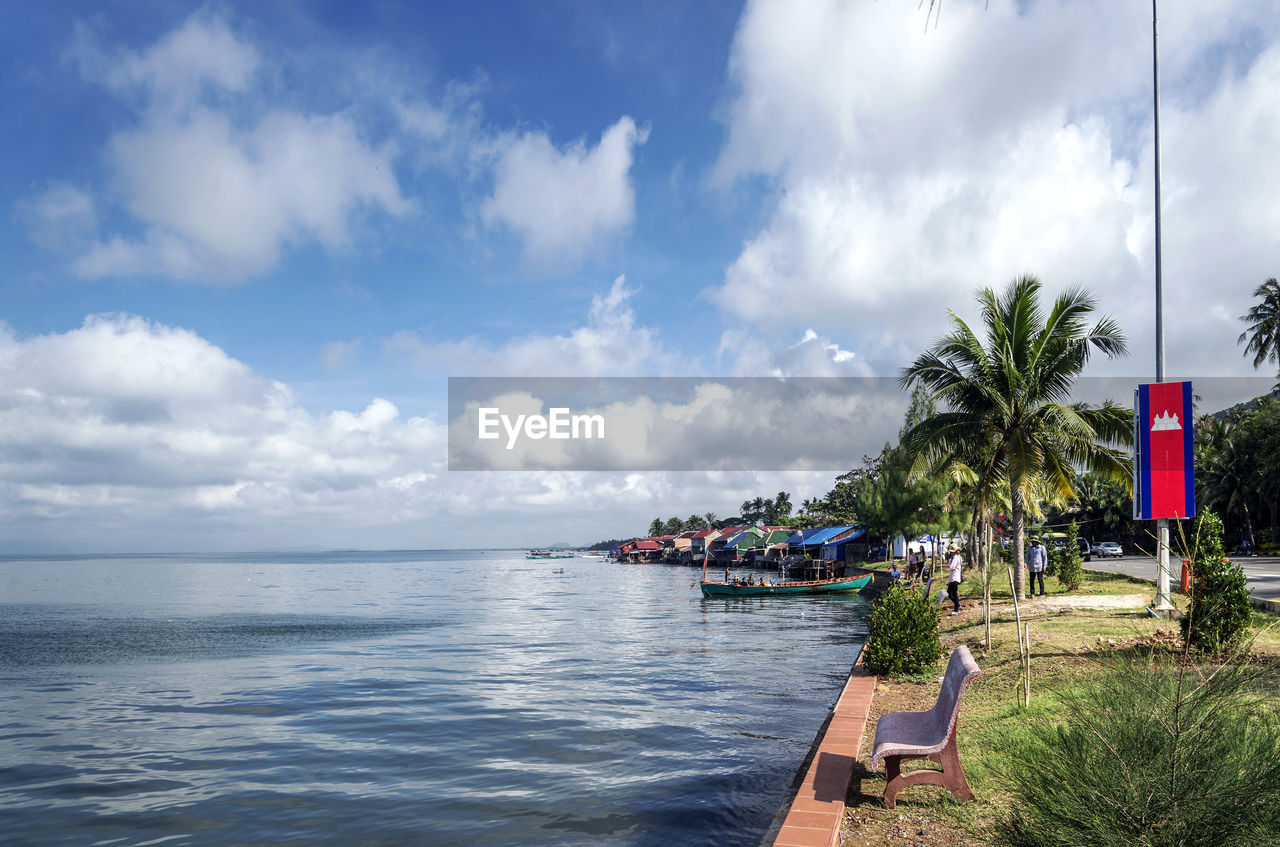 PANORAMIC VIEW OF SEA AND PALM TREES AGAINST SKY