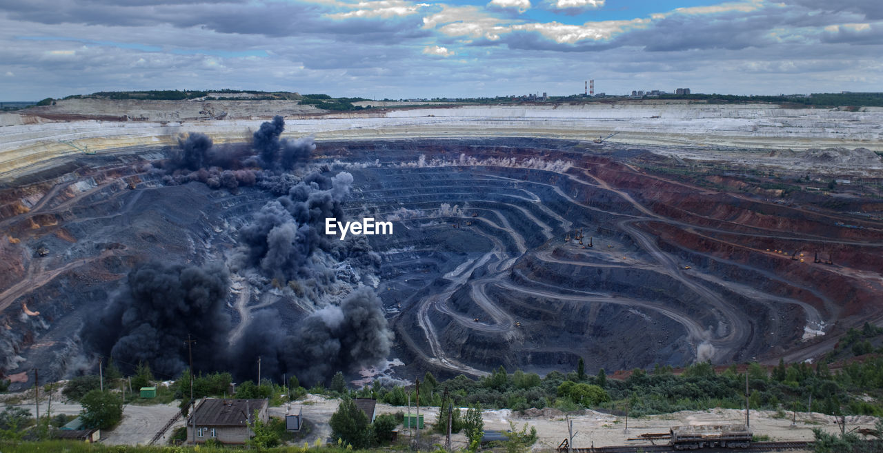 High angle view of mining on mountain against cloudy sky