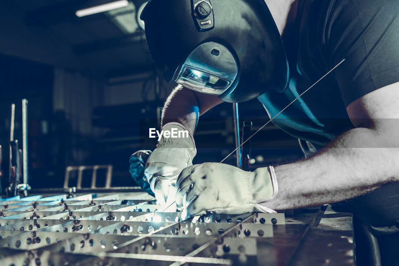 midsection of man working in workshop