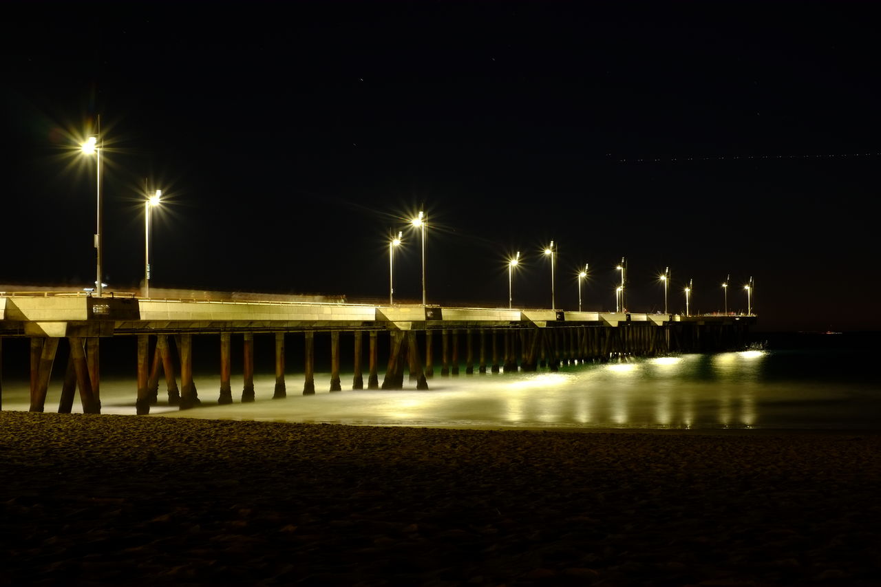 Illuminated pier at night