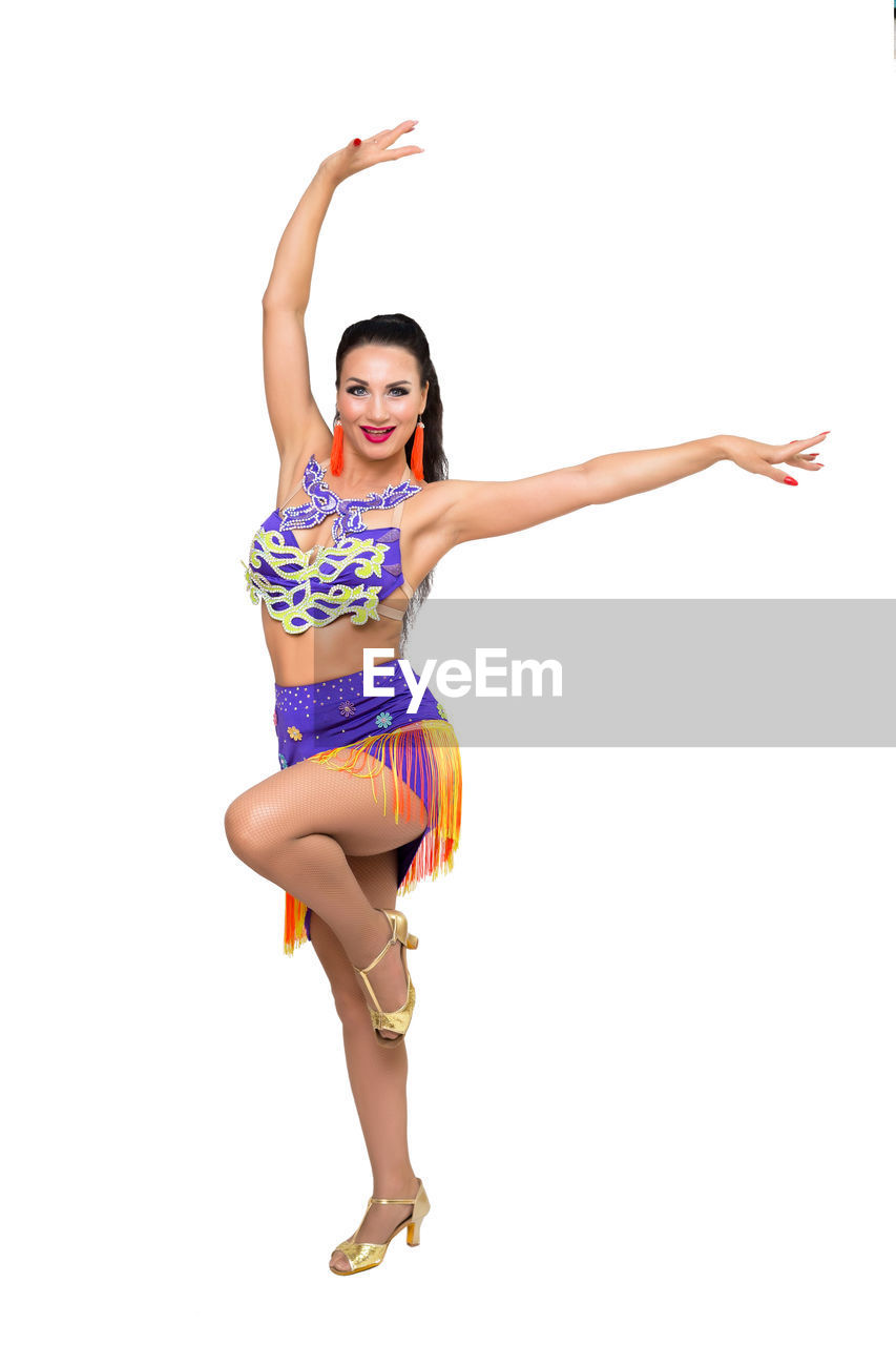 full length, white background, arm, limb, sports, women, studio shot, one person, young adult, human limb, cut out, portrait, arms raised, adult, happiness, smiling, performing arts, clothing, vitality, indoors, lifestyles, dancing, modern dance, emotion, cheerful, front view, looking at camera, arms outstretched, copy space, jumping, female, balance, motion, flexibility, positive emotion, dancer, fashion, arts culture and entertainment, entertainment, mid-air